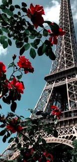 Eiffel Tower with red roses under a blue sky.