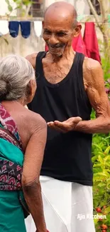 Elderly couple sharing a joyful moment in a lush garden.