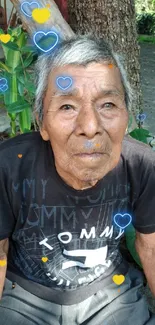 Elderly man sitting in a lush garden.