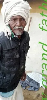 Portrait of elderly man in village setting, wearing traditional attire.