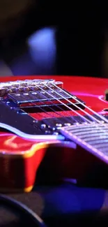 Glossy red electric guitar with chrome detailing on a vibrant background.