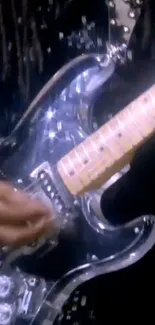 Close-up image of a metallic electric guitar with player's hand.