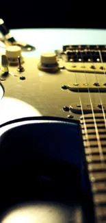 Close-up of electric guitar strings with a dark blue and black background.