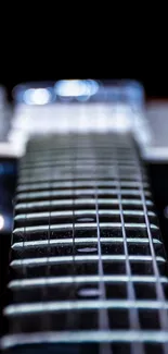 Electric guitar strings close-up with dark background.