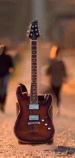 Electric guitar on a path during sunset with blurred figures in the background.