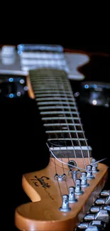 Close-up of electric guitar strings on a dark background.