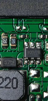 Close-up view of a mobile phone circuit board with green pathways and components.