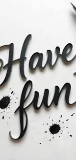 Elegant 'Have Fun' script with ink splatters and pen.