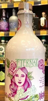 Elegant pink Eternal Absinthe bottle in a vintage bar setting.