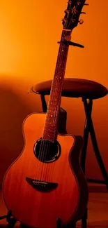 Elegant acoustic guitar on stool in warm lighting.