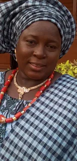 Woman in elegant African attire with bold patterns and colors.