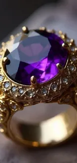 Gold ring with a large purple amethyst gemstone.