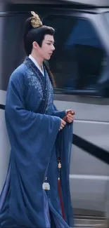 Man wearing blue traditional Chinese robe.