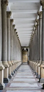 Elegant stone columns with a white ceiling create a timeless architectural passage.