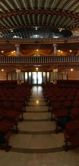 Elegant interior of a grand hall with ornate ceiling and rows of chairs.