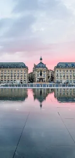 Scenic European building reflecting in water at sunset.