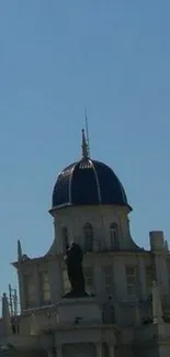 Silhouette of a dome building under a clear blue sky.