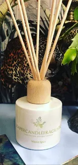 Elegant diffuser with greenery and artistic decor in an aromatherapy setting.