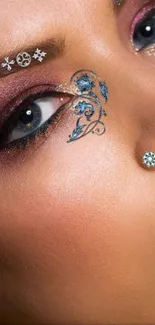 Artistic face with blue design and intricate makeup. Elegant and fashionable.