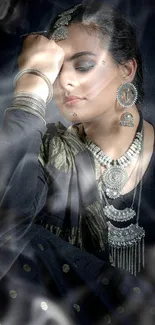 Elegant portrait of a woman with silver jewelry against a dark background.