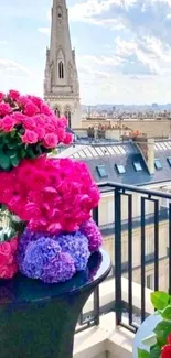 Colorful flowers on a Parisian balcony with a city view.