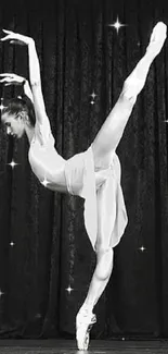 Black and white image of a graceful ballerina in a poised dance pose.