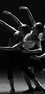 Ballet dancers gracefully poised in a striking silhouette.