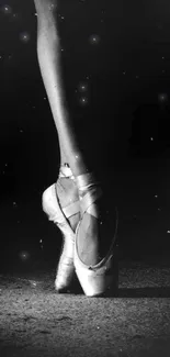 Elegant ballet dancer's feet poised in grayscale background.