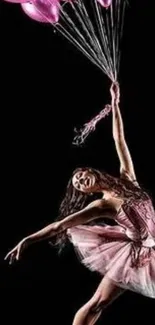 Graceful ballerina with pink balloons on a black background.