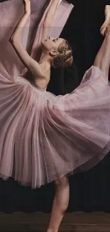 Elegant ballet dancer posing in a pink dress.