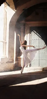 Ballet dancer poised in sunlit archway.