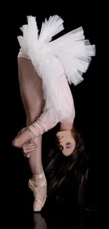 Ballerina in elegant pose against a black background.