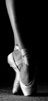 Black and white ballet pose showcasing elegant pointe shoes.