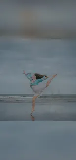 Graceful dance leap on serene beach background wallpaper.