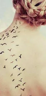 Stylish back tattoo with birds in flight design.