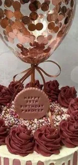 Elegant birthday cake with balloon decoration in burgundy and white.