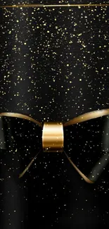 Elegant golden bow with sparkles on black background wallpaper.