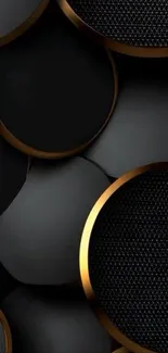 Black circles with gold trim on wallpaper.