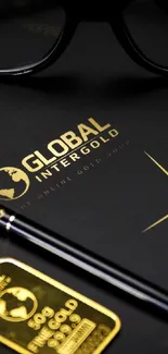 Black notebook with gold accents, pen, and gold card on desk.