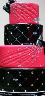 Three-tier pink and black cake with elegant decorations.