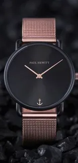 Elegant black and rose gold watch on dark background.