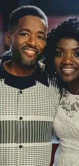 Couple smiling elegantly in black and white attire.