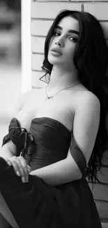 Elegant black and white portrait of a woman in a dress.