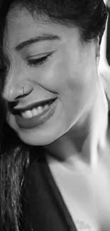 Black and white portrait of a smiling woman.