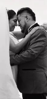 Black and white wedding couple embracing joyfully.