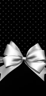 Elegant black wallpaper with a silver ribbon and bow design.