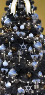 Elegant black Christmas tree with silver and gold ornaments.