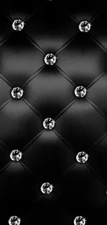 Black quilted wallpaper with diamond accents.