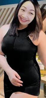 Smiling woman in elegant black dress portrait.