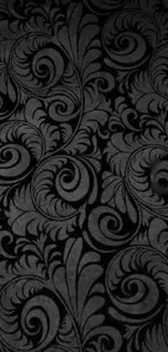 Elegant dark floral pattern wallpaper with intricate swirls and leaves.